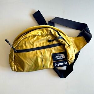 North face supreme gold cross body bag - has green stain on it